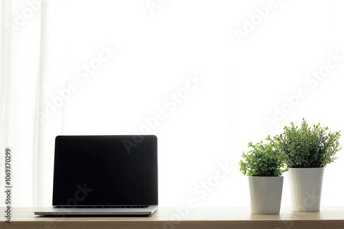 A laptop computer sits on top of a wooden desk, ready for use photo