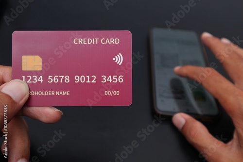 hand holding credit card and scrolling online shop on samrtphone photo