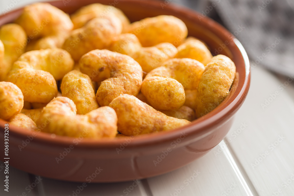 Puffed crispy Peanut flips in bowl on white table. Puffed crispy Peanut flips in bowl on white table.