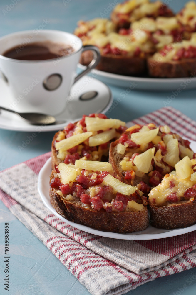 Homemade hot sandwiches with sausage, cheese and pineapple on blue background. Delicious breakfast or snack Homemade hot sandwiches with sausage, cheese and pineapple on blue background. Delicious breakfast or snack