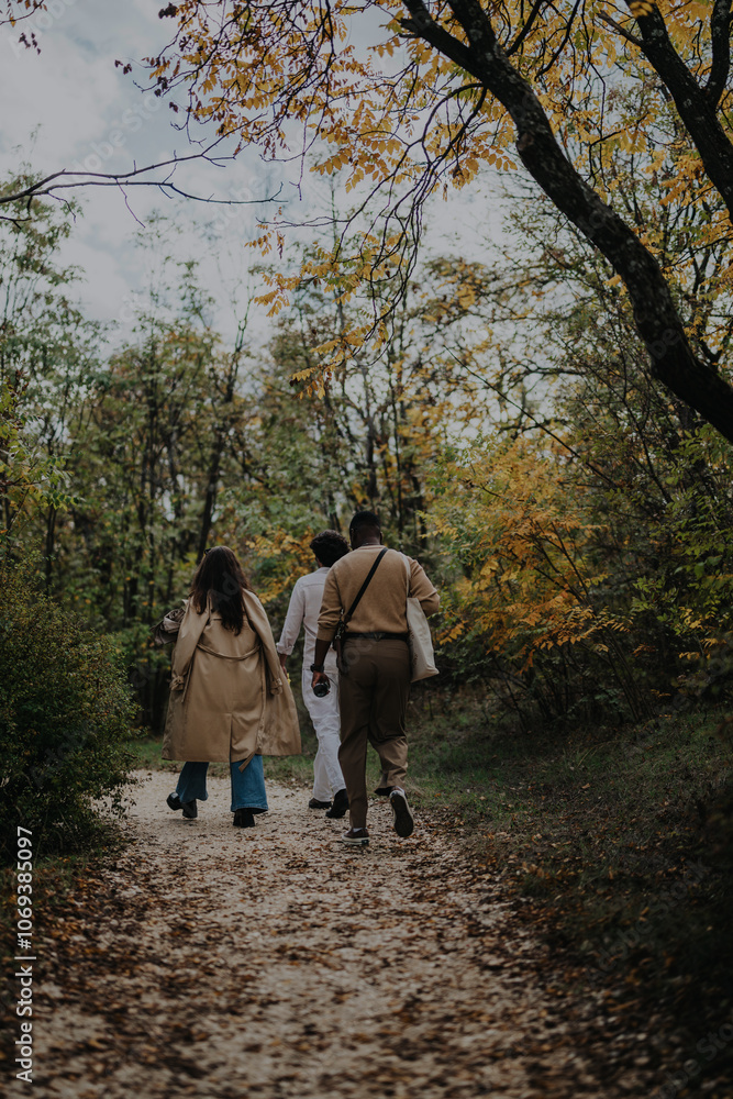 A group of friends enjoying a walk together on a scenic forest trail surrounded by autumn foliage, capturing moments of connection and natural beauty. A group of friends enjoying a walk together on a scenic forest trail surrounded by autumn foliage, capturing moments of connection and natural beauty.