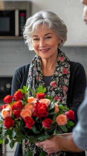 Woman receives a beautiful bouquet of roses in a cozy kitchen setting during daytime