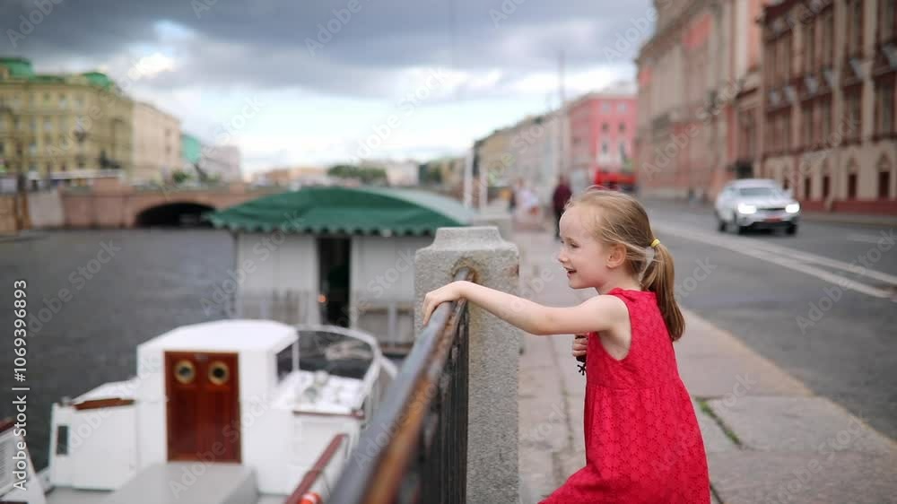Adorable preschooler girl having fun on Fontanka embankment in Saint-Petersburg, Russia. Adorable preschooler girl having fun on Fontanka embankment in Saint-Petersburg, Russia.
