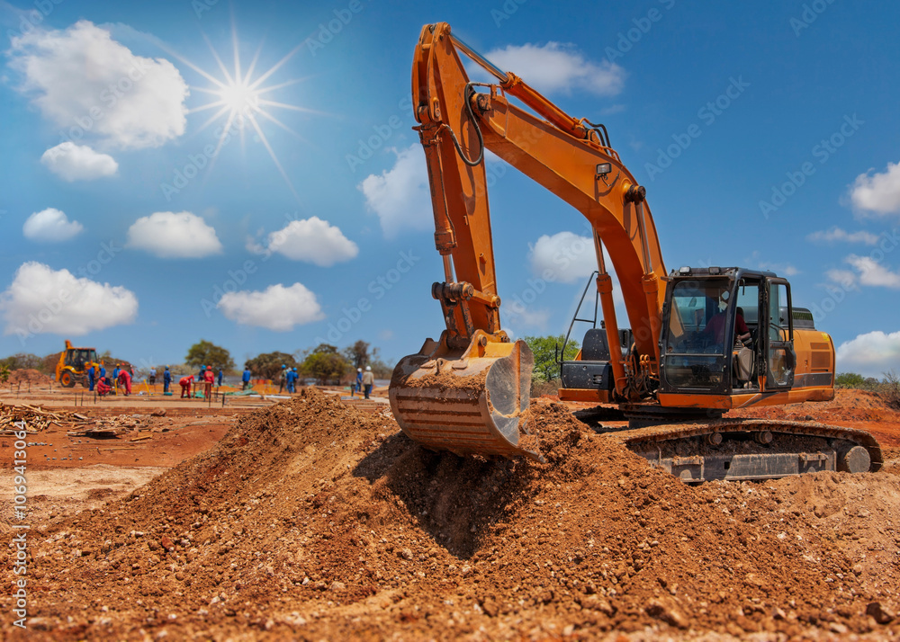 excavator digging on construction site, workers in the background, sunny day excavator digging on construction site, workers in the background, sunny day