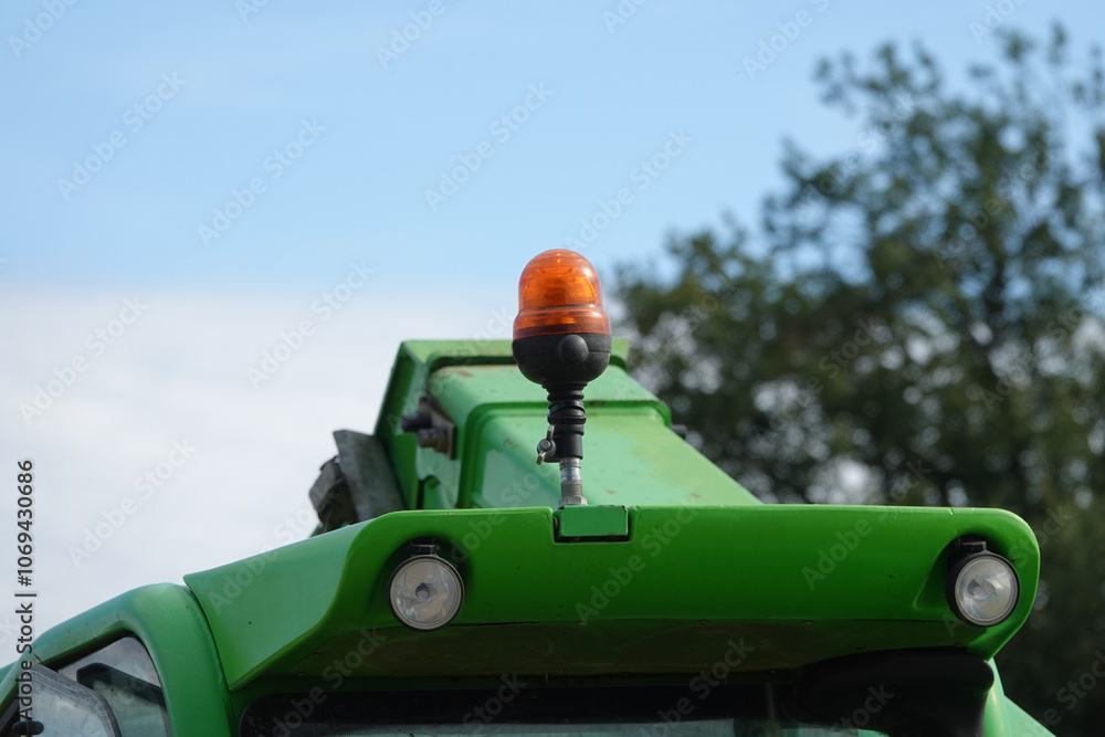 Signal orange dome LED light at tractor