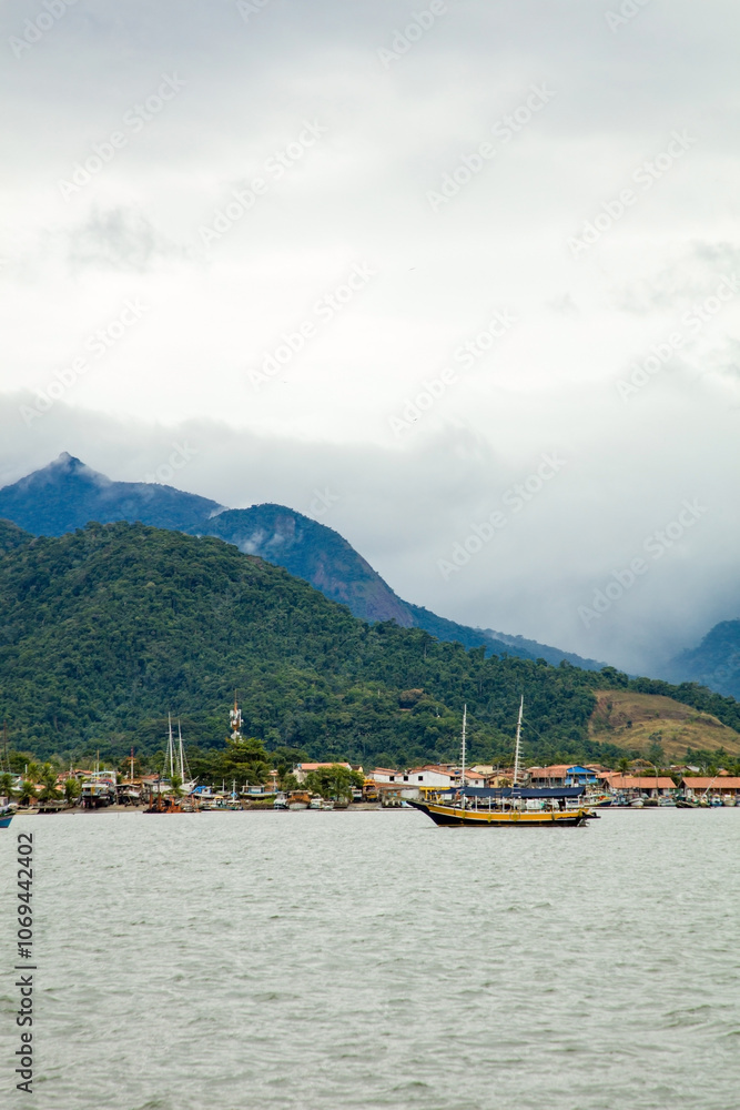 Tourist boat dock in Paraty Bay in Rio de Janeiro, Brazil, where passenger boats await customers to be taken to nearby islands or other villages. world heritage Tourist boat dock in Paraty Bay in Rio de Janeiro, Brazil, where passenger boats await customers to be taken to nearby islands or other villages. world heritage