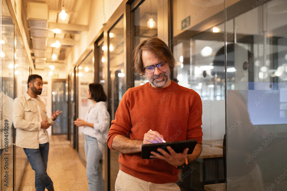 Professionals collaborating in a modern coworking space Professionals collaborating in a modern coworking space