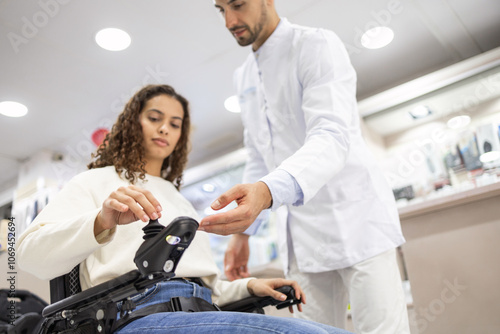 Professional assistance and modern wheelchairs in orthopedic store photo