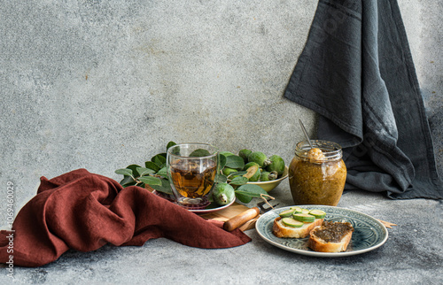 Floral tea and sandwiches with fresh feijoa fruits and jam photo