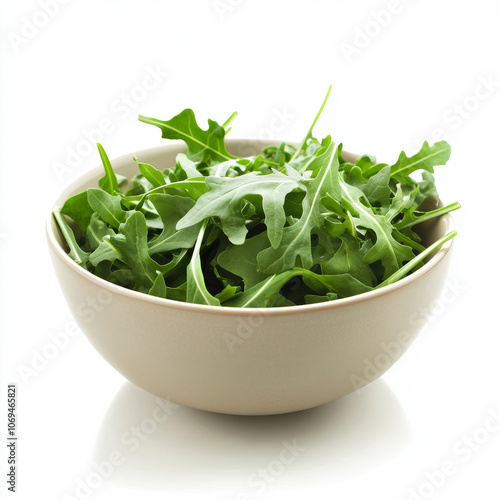 A bowl of fresh arugula, isolated on a white background, emphasizing a peppery green