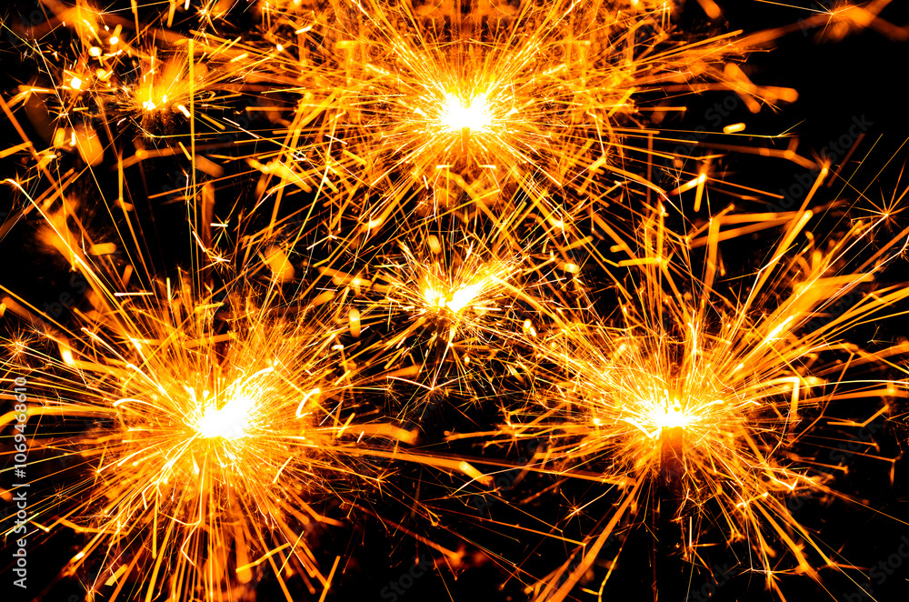 Christmas sparkler on black background. Background of sparkles. Festive Christmas sparkle. Fiery sparkle background. Firework sparkle effect New Year backgrounds. Copy space background. Christmas sparkler on black background. Background of sparkles. Festive Christmas sparkle. Fiery sparkle background. Firework sparkle effect New Year backgrounds. Copy space background.