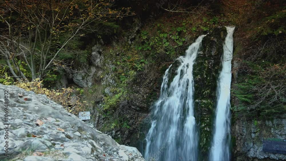 Waterfall in the mountains with autumn vegetation Waterfall in the mountains with autumn vegetation