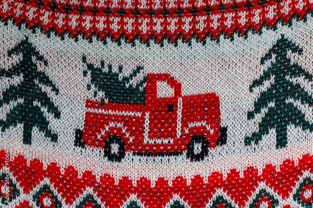 Jacquard Christmas knitting close-up. Red car and ornament on knitted sweater. Jacquard Christmas knitting close-up. Red car and ornament on knitted sweater.