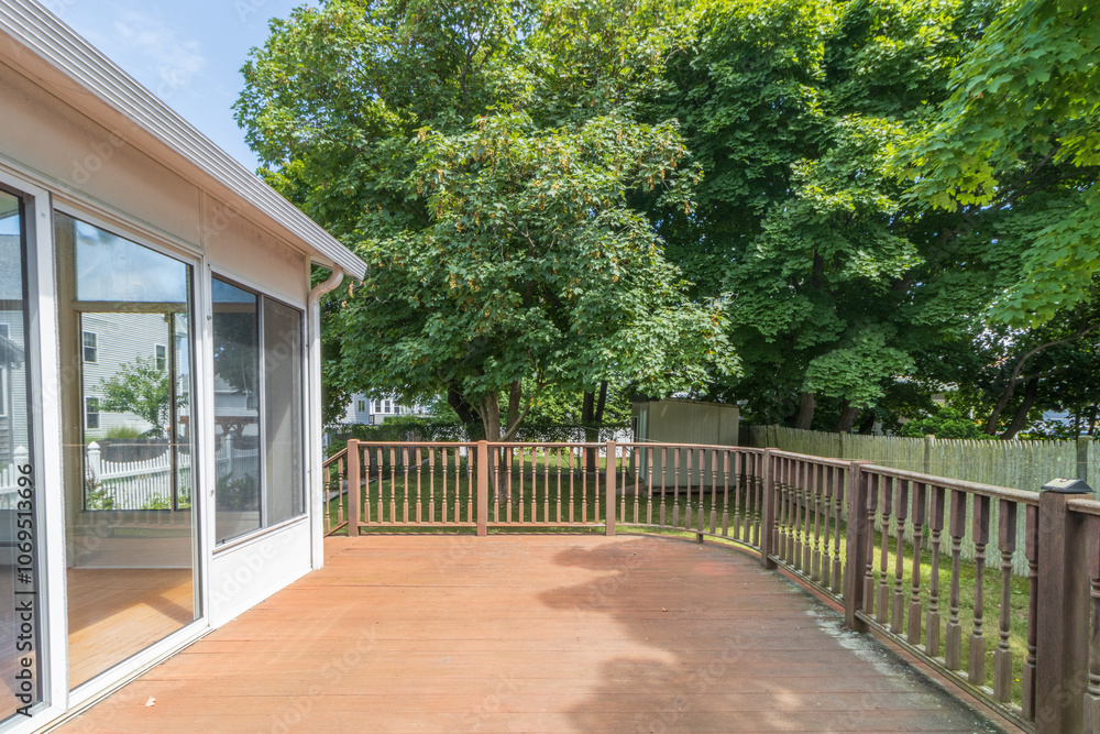 Naklejka premium spacious deck overlooking backyard woods