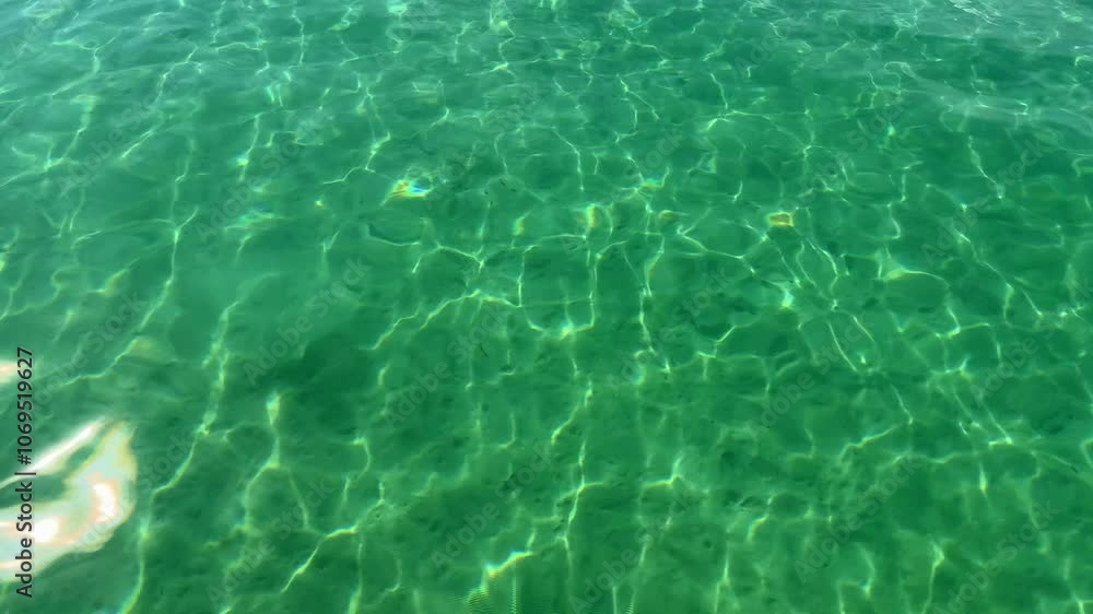 Crystal clear water with rippling sunlight in swimming poo Crystal clear water with rippling sunlight in swimming poo