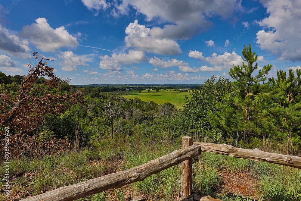 Hilltop overlooking green pastures, livestock, and giant clouds on a spring morning. Hilltop overlooking green pastures, livestock, and giant clouds on a spring morning.