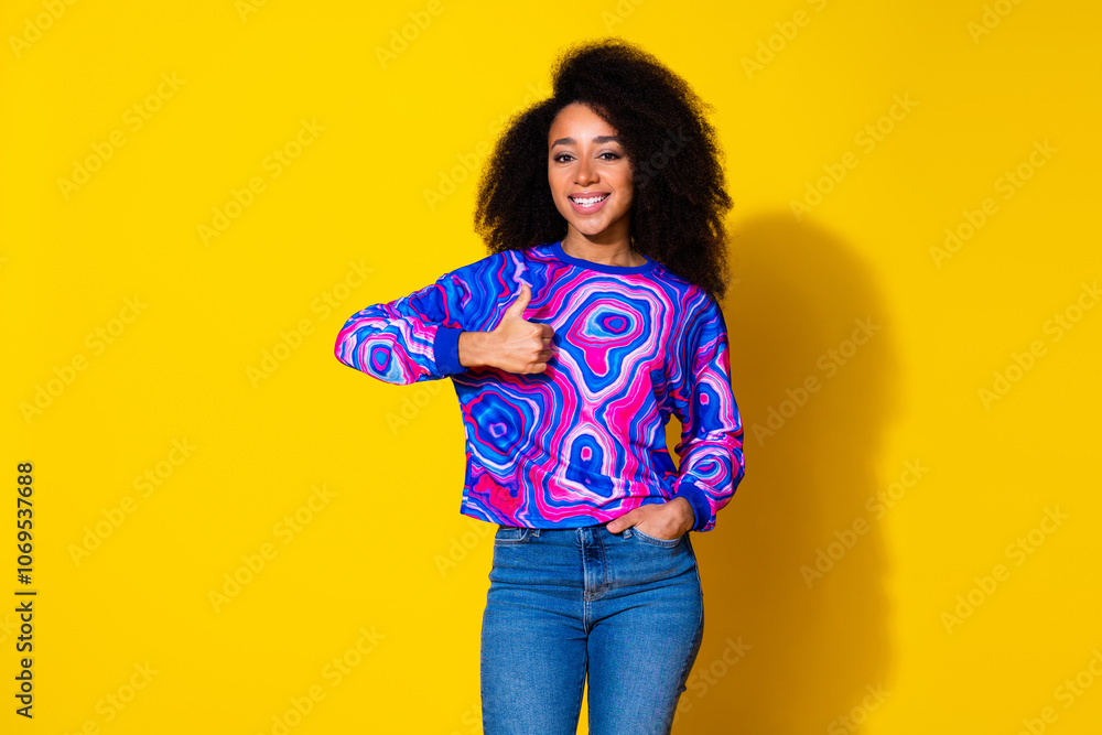 Photo portrait of attractive young woman show thumb up approve dressed stylish colorful blue clothes isolated on yellow color background Photo portrait of attractive young woman show thumb up approve dressed stylish colorful blue clothes isolated on yellow color background