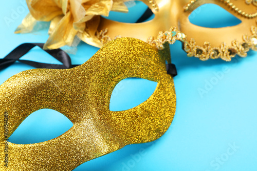 Beautiful carnival masks on light blue background, closeup