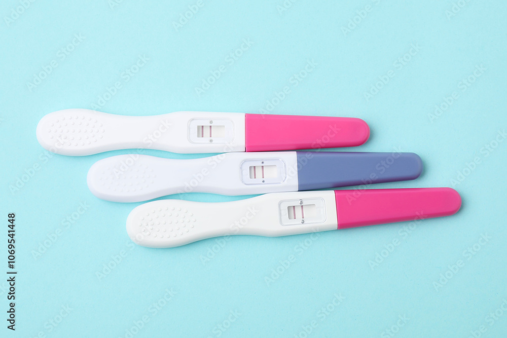 Pregnancy tests on light blue background, above view Pregnancy tests on light blue background, above view