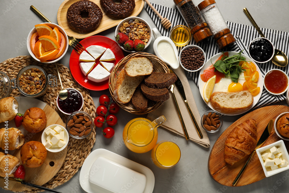 Different tasty food served for brunch on grey table, flat lay