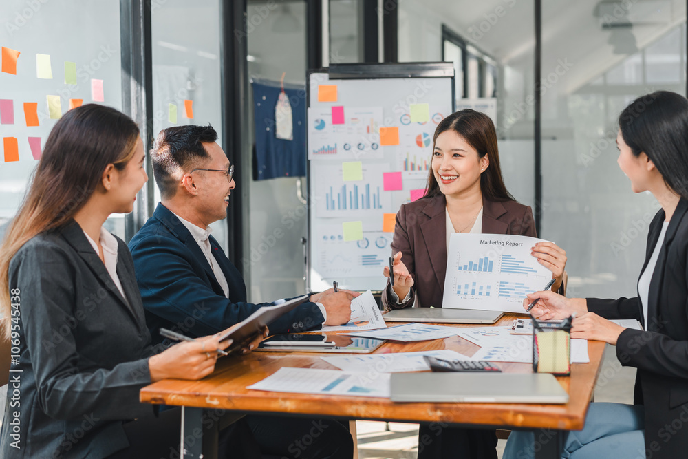 Professional team discussing marketing reports in modern office. They analyze data and collaborate on strategies, showcasing teamwork and communication Professional team discussing marketing reports in modern office. They analyze data and collaborate on strategies, showcasing teamwork and communication