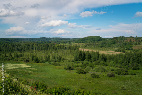 View of the Izborsko-Malskaya Valley and the village of Izborsk on a sunny summer day, Pechersk district, Pskov region, Russia photo