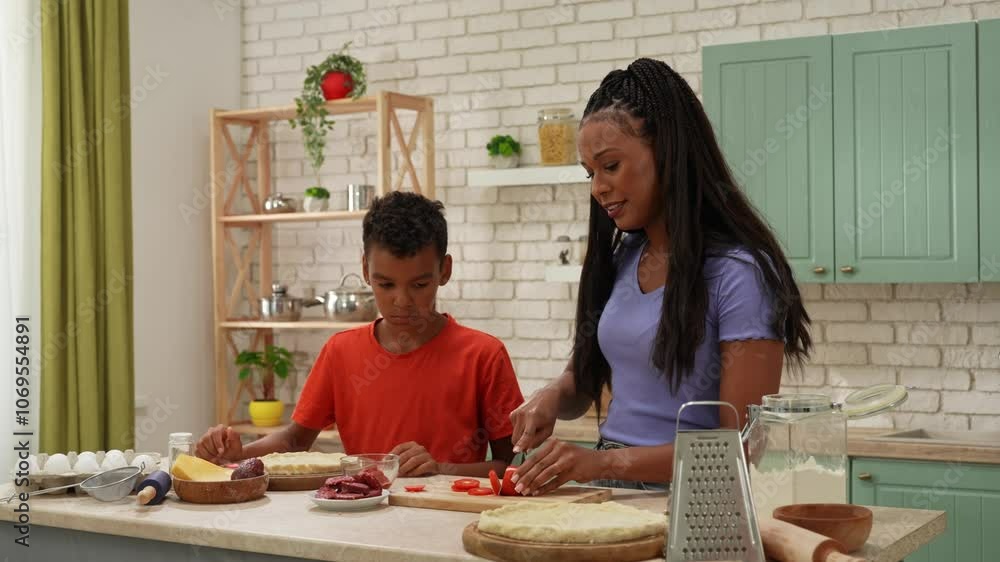 African American happy family preparing food in the kitchen. African American happy family preparing food in the kitchen.