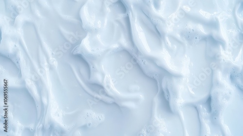 Creamy textured surface with soft white waves and fluid patterns