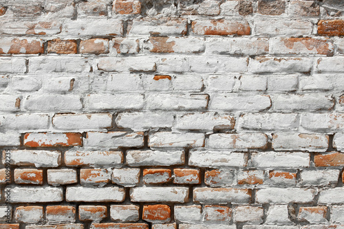 White shabby grungy brick wall. Free space for an inscription. Can be used as a background or poster. Fragment of a red brick wall with bumps and textured plaster.	
 photo