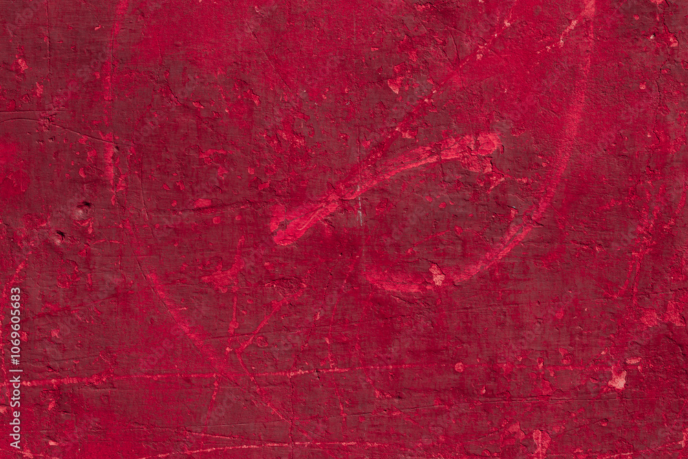 Fototapeta premium Red texture of a concrete wall with natural relief and damage in the form of chips and scratches. Fragment of an old stone surface with a crack. Dark rough surface with a place for an inscription