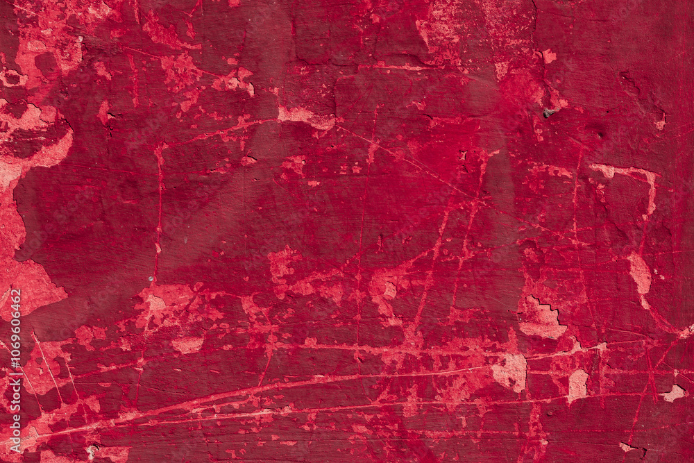 Obraz premium Red texture of a concrete wall with natural relief and damage in the form of chips and scratches. Fragment of an old stone surface with a crack. Dark rough surface with a place for an inscription