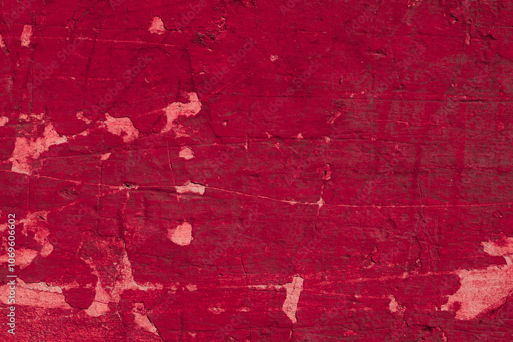 Obraz premium Red texture of a concrete wall with natural relief and damage in the form of chips and scratches. Fragment of an old stone surface with a crack. Dark rough surface with a place for an inscription