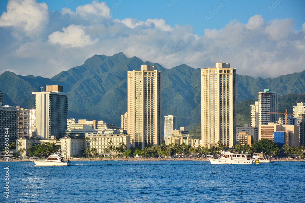 Waikiki skyline view from boat with Koolau mountains in the background in Honolulu on Oahu, Hawaii. Waikiki skyline view from boat with Koolau mountains in the background in Honolulu on Oahu, Hawaii.