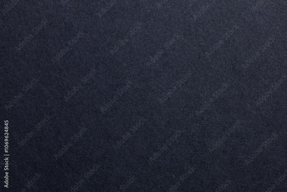 A black background with a few specks of white, textured origami paper backdrop A black background with a few specks of white, textured origami paper backdrop