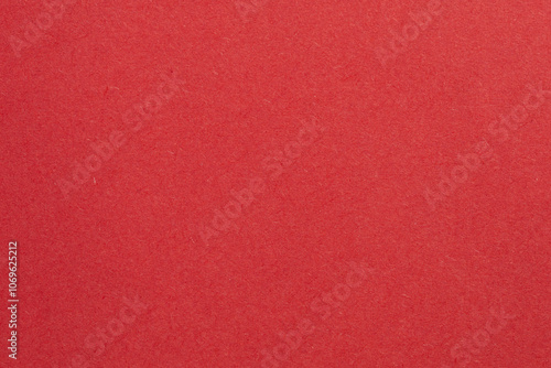 A red background with a white object in the middle, textured origami paper backdrop