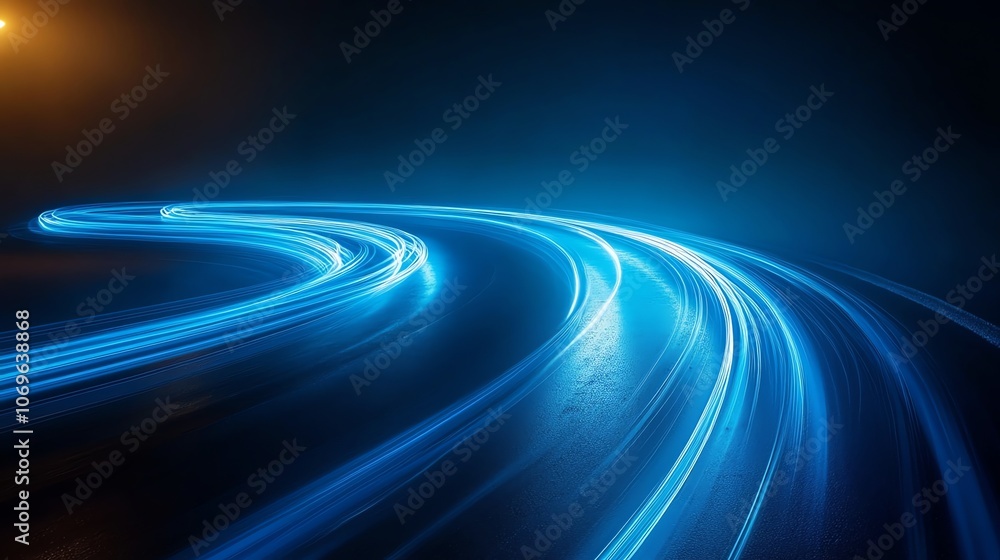 Abstract blue light trails on a dark road creating a speed and motion effect. Abstract blue light trails on a dark road creating a speed and motion effect.