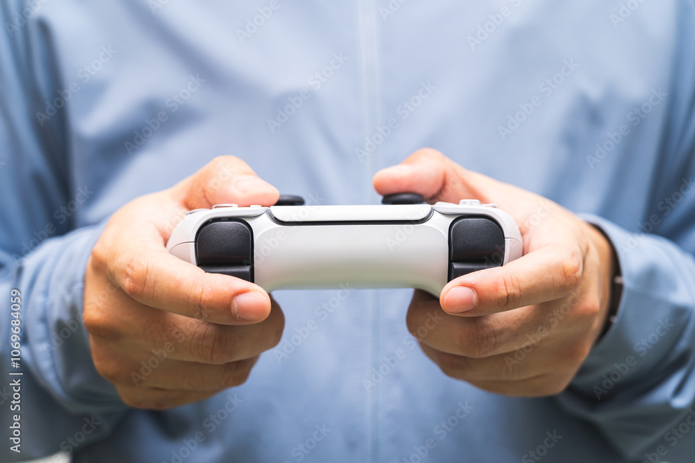 Fototapeta premium Man holding Game controller. Person holding the game controller.