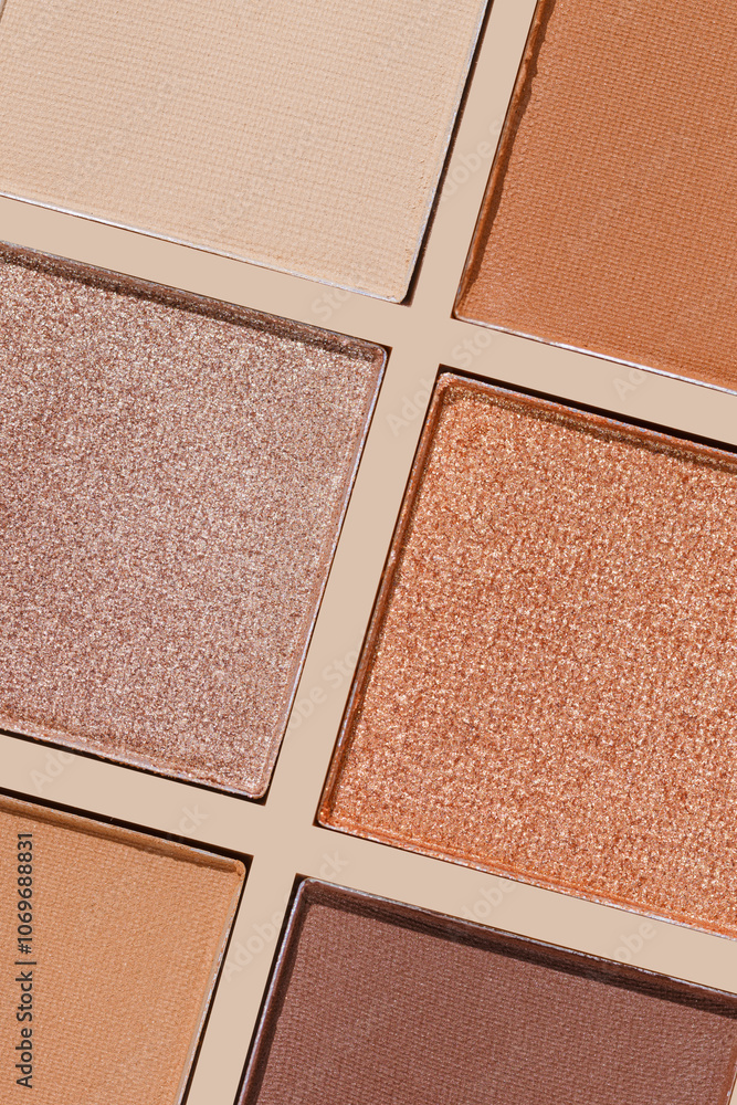Fototapeta premium Swatches eyeshadow refills as minimal graphic pattern. Matte and glitter pans beige brown copper shade, detailed texture, sun light, minimal trend cosmetics background, beauty product, eye makeup