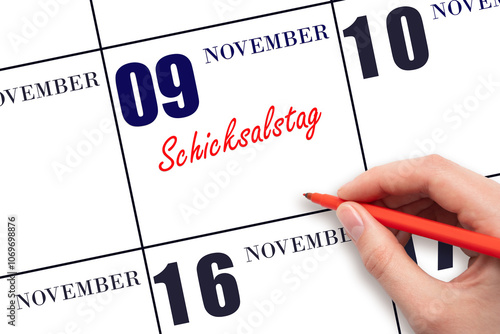 November 9. Hand writing text Schicksalstag on calendar date. Save the date. photo