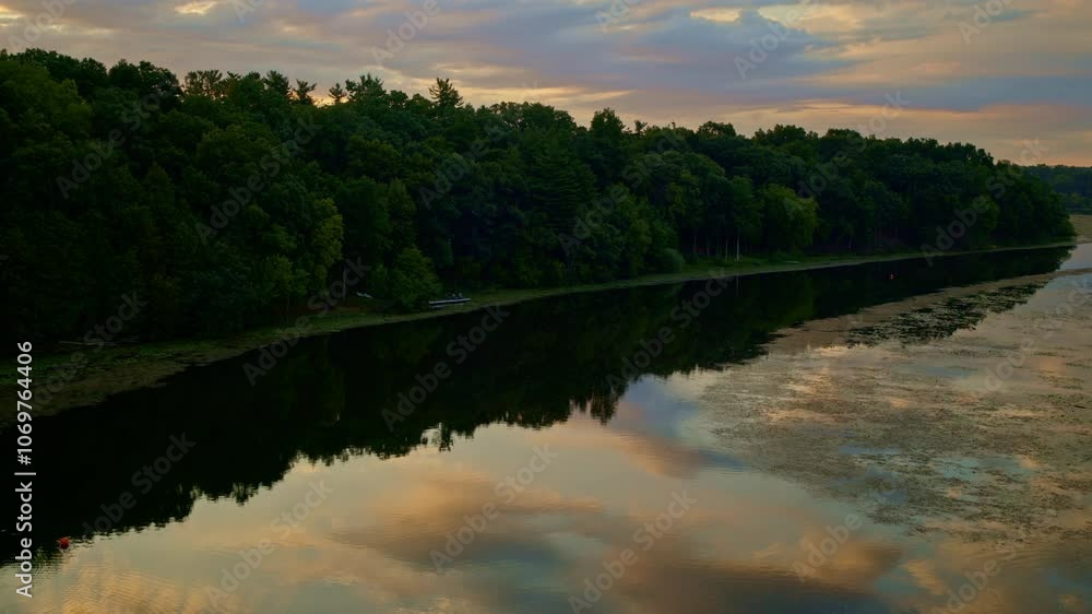 Drone capturing a slow, serene view of the Huron River in Ann Arbor, Michigan, during summer. Drone capturing a slow, serene view of the Huron River in Ann Arbor, Michigan, during summer.