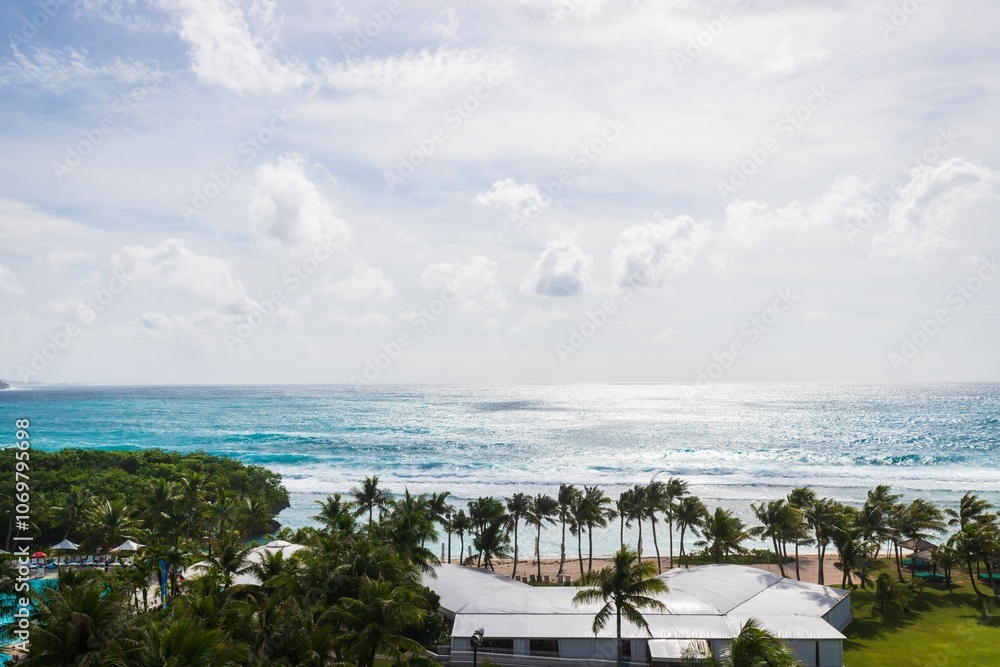 Fototapeta premium Panoramic View of a Tropical Paradise with Turquoise Waters and Palm Trees, Guam