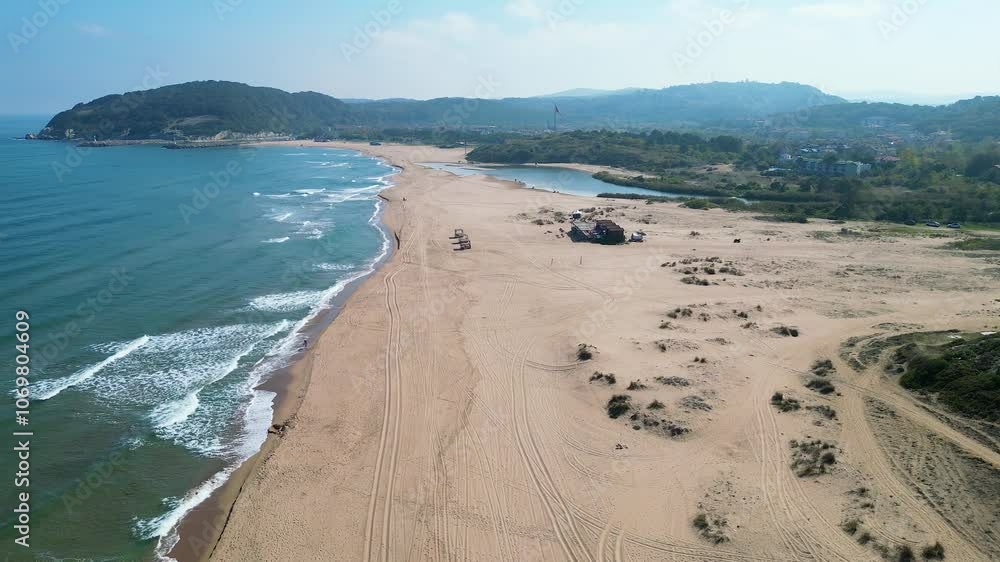 An aerial view of sea waves breaking greenery beach An aerial view of sea waves breaking greenery beach