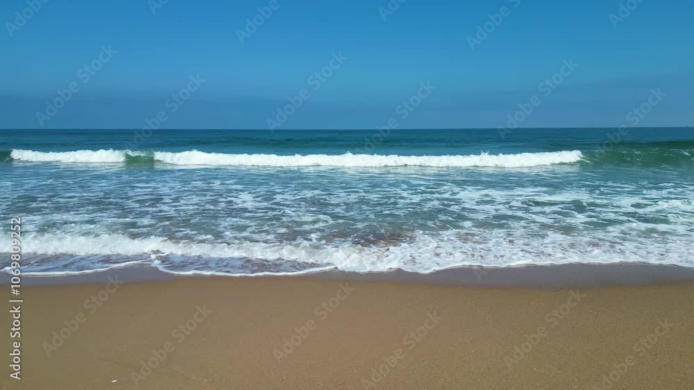 Waves of Mediterranean Sea rolling in sunshine to the sandy beach. Beautiful Turkish nature. Close-up shot of calming foamy water. Waves of Mediterranean Sea rolling in sunshine to the sandy beach. Beautiful Turkish nature. Close-up shot of calming foamy water.