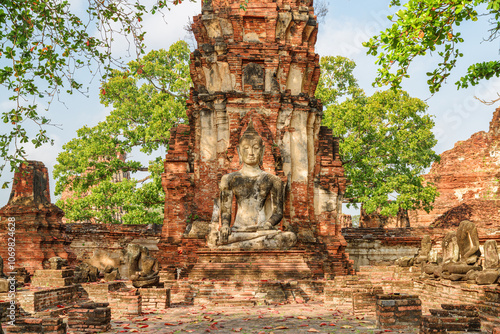 Buddha statue among ruins of the Wat Mahathat in Ayutthaya