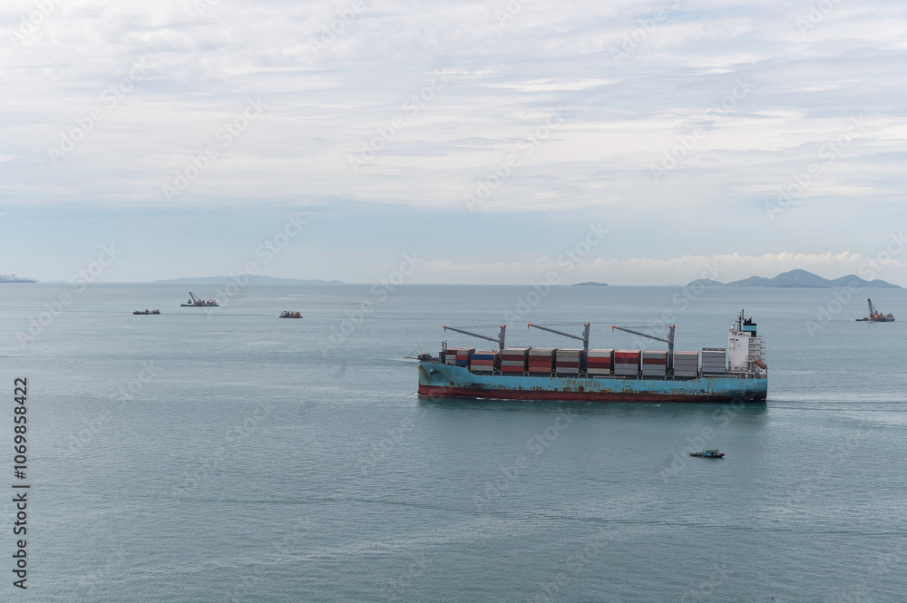 Fototapeta premium container ship commercial vessel alongside in port for loading and discharging containers services in maritime transports in World wide logistics