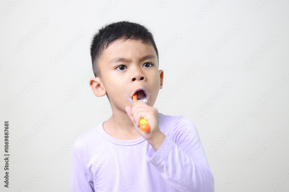 child Asia kid boy brushing teeth isolated on white backgroud. child Asia kid boy brushing teeth isolated on white backgroud.