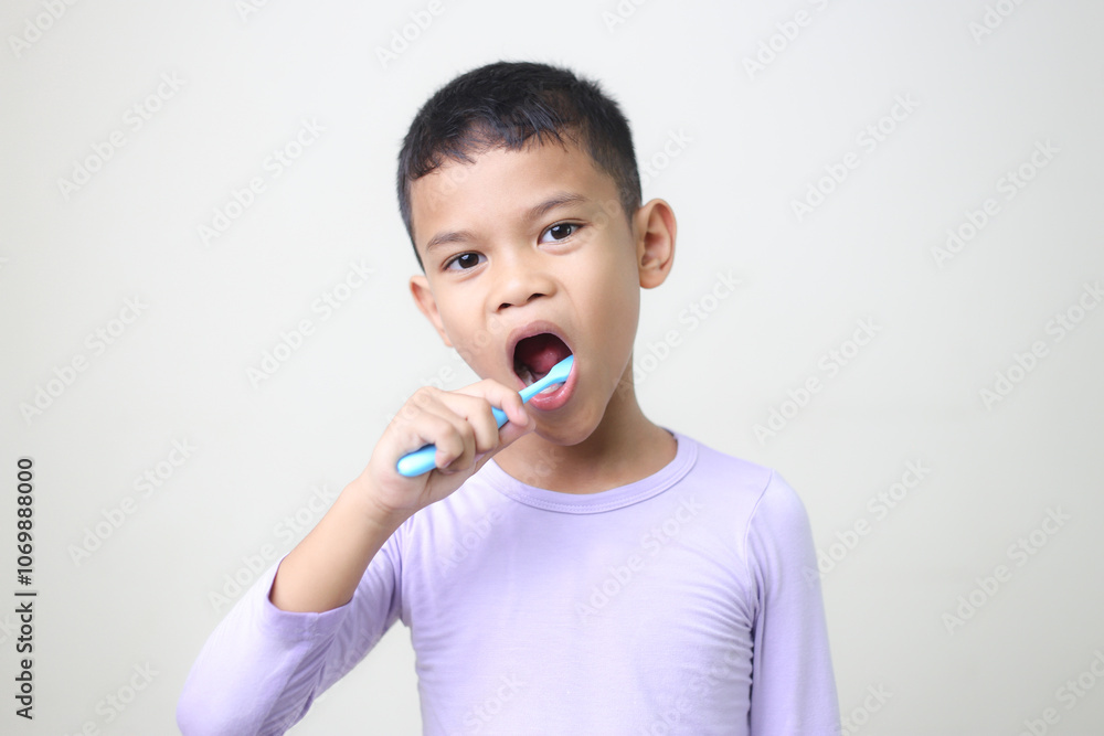 child Asia kid boy brushing teeth isolated on white backgroud. child Asia kid boy brushing teeth isolated on white backgroud.