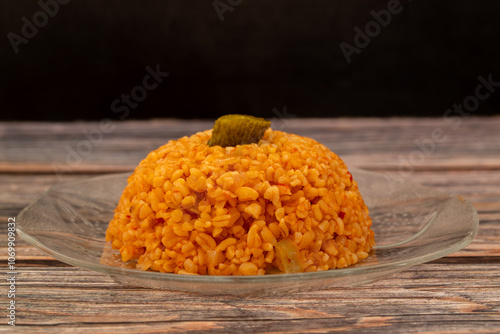 Traditional turkish bulgur pilaf with tomato sause in plate (Turkish name; meyhane pilavi) photo