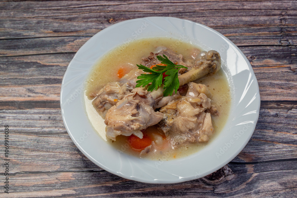 Boiled chicken thighs with potatoes and carrots in a white plate. Boiled chicken meat. Boiled chicken thighs with potatoes and carrots in a white plate. Boiled chicken meat.