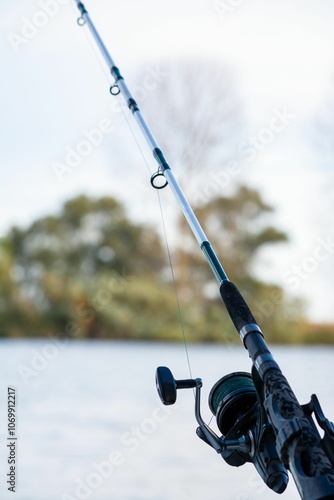 Fishing rod with serene outdoor backdrop. photo